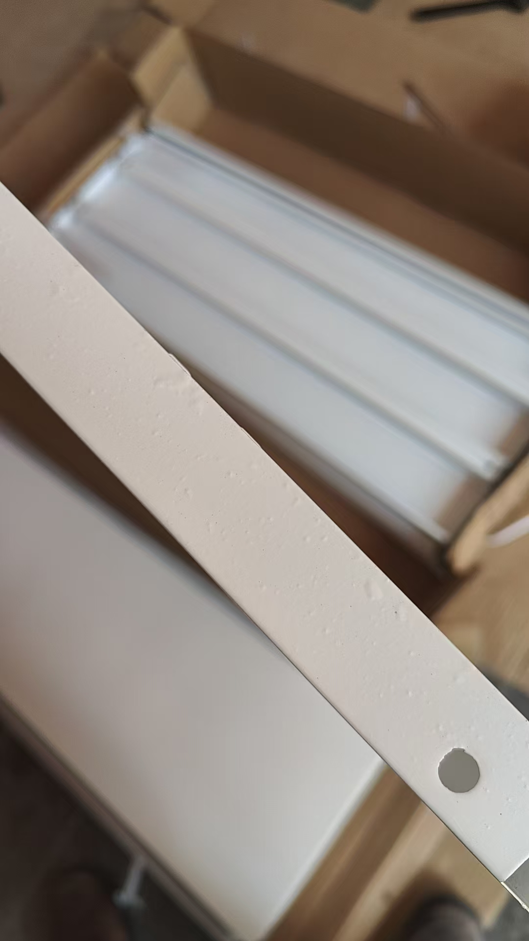 Surface coating damage visible on supermarket shelving