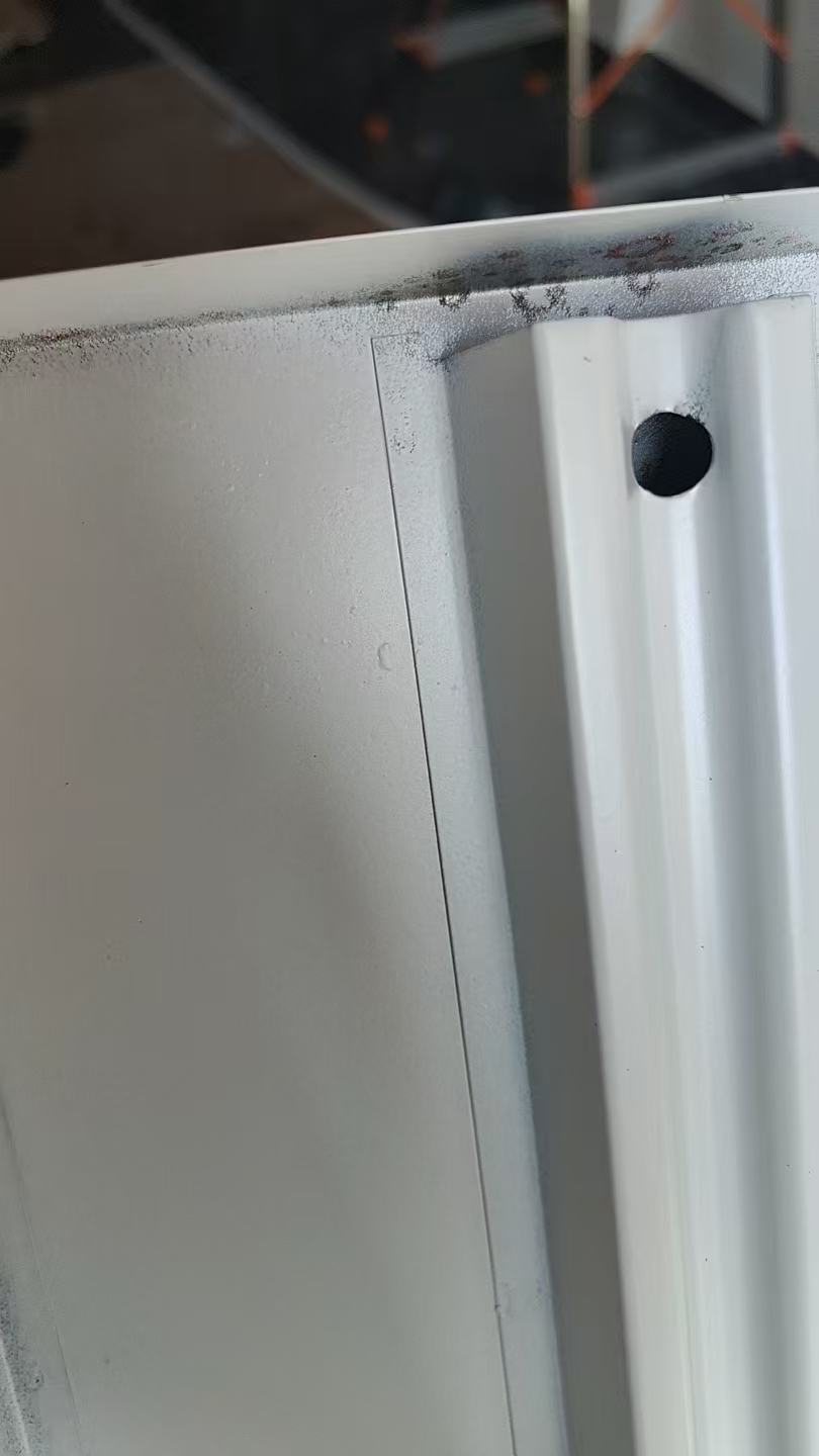 Supermarket shelving showing paint peeling after months of use